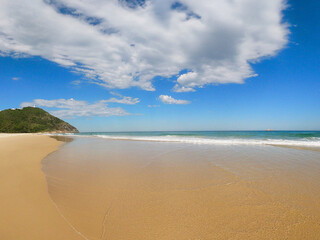 white sandy beach and cloudy blue sky 