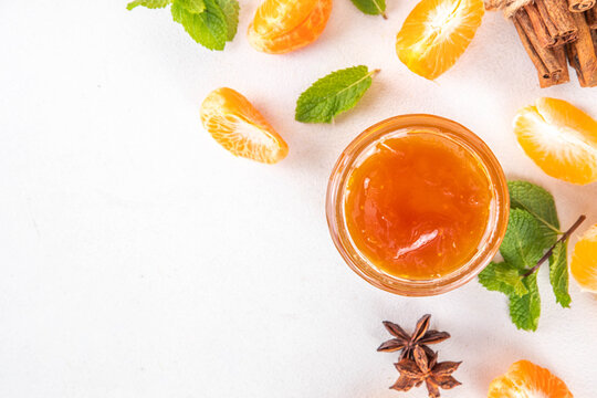 Golden sweet homemade tangerine jam, with spices and mint