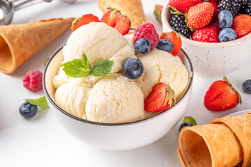 White ice cream bowl with vanilla gelato and fresh berries