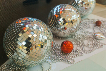 disco balls on the floor of the room. mirrored balls in the shop window