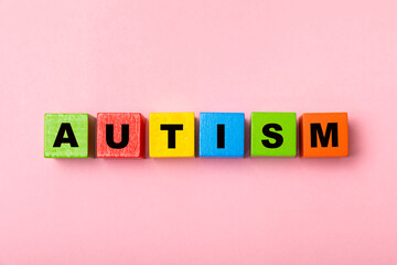 Autism awareness day.2 April world autism awareness day background.Design element.Care Awareness campaign for Autism.AUTISM text with colorful wooden puzzles, letters and cubes.Space for text.Top view