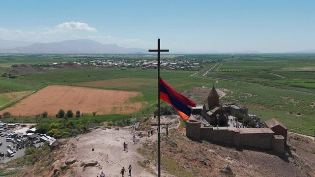 Aerial shot Armenian flag and Khor Virap monastery. Khor Virap Monastery In The Ararat Plain In Armenia. Touristic, famous place in Armenia, West Asia. Armenian flag on the background of Mount Ararat 