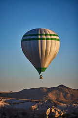 Obraz premium Balloons lifted into the air in Cappadocia. Entertainment and tourist attraction. A spectacular sight