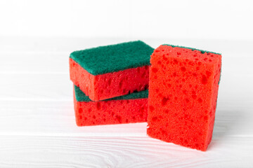 Colorful dish sponges on textured background. Kitchen sponge. Cleaning concept, cleaning service. Dishwashing liquid with clean and dirty dishes plate. Place for text, copy space. Wash the dishes.