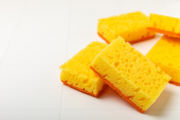 Colorful dish sponges on textured background. Kitchen sponge. Cleaning concept, cleaning service. Dishwashing liquid with clean and dirty dishes plate. Place for text, copy space. Wash the dishes.