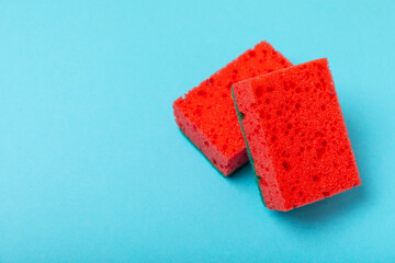 Colorful dish sponges on textured background. Kitchen sponge. Cleaning concept, cleaning service. Dishwashing liquid with clean and dirty dishes plate. Place for text, copy space. Wash the dishes.