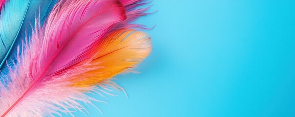 Fototapeta premium Colorful feathers in vibrant hues of pink, orange, and blue against a bright background, creating a playful and artistic vibe.