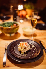 Festive shrimp toast dinner with champagne in a cozy candlelit cabin.