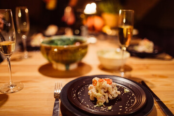 Festive shrimp toast dinner with champagne in a cozy candlelit cabin.