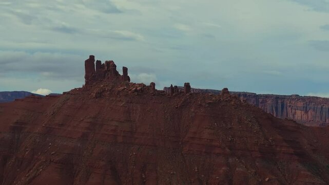 A breathtaking desert mesa with rocky spires in Moab, Utah, under cloudy skies