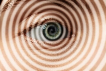 Hypnosis. Spiral symbolizing hypnotic effect coming out of woman's eye, closeup