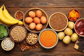 Different products rich in iron on wooden table, flat lay. Diet plan for anemia