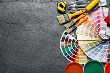 Flat lay composition with different painter's tools on grey table, space for text. Decorating and...