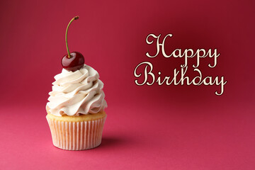 Happy Birthday greeting card. Sweet cupcake with cherry on crimson color background
