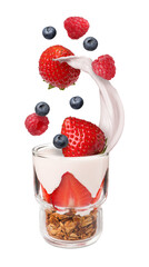 Fresh berries falling into glass with yogurt and granola on white background