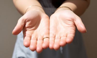 Close-up of open hands with fingers slightly spread apart conveying a sense of openness