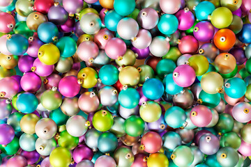 A huge pile of different colorful christmas baubles