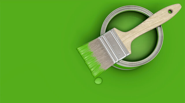 Gr&uuml;ne Farbdose mit Pinsel auf gr&uuml;nem Untergrund