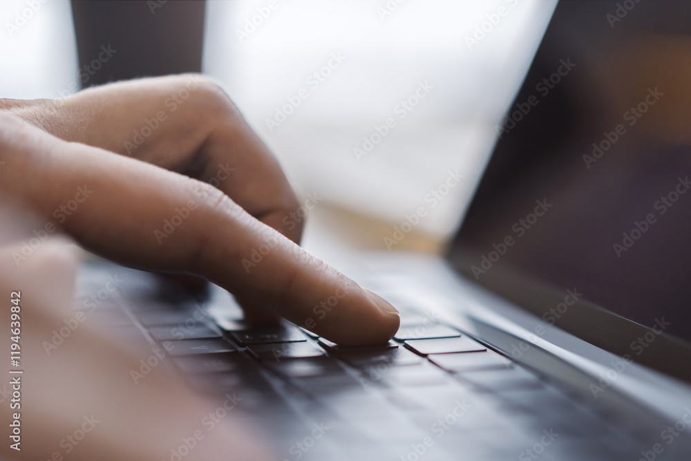 Poster a man's hands are captured up close, busily typing on a sleek laptop keyboard, set against a fuzzy o