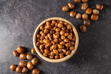 Hazelnuts in a wooden bowl, top view