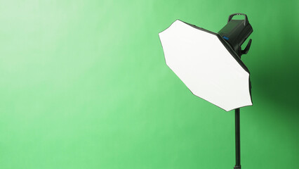 Studio flash light on green screen backround.