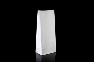 Recyclable craft paper bag for purchases, gifts and takeaway food mock up on black background. Environmentally friendly than single-use plastic bags