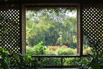 This image captures a picturesque view of a lush green garden, seen through a beautifully crafted window frame with intricate latticework. Ideal for nature or decor themes.