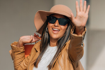 young fashion girl shopping waving