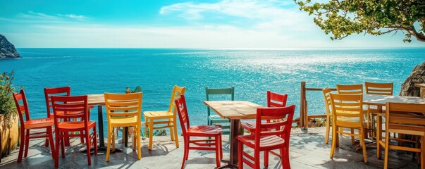 Fototapeta premium A sunny terrace cafÃ© by the seaside, with a view of the ocean and colorful chairs, 4k photo.