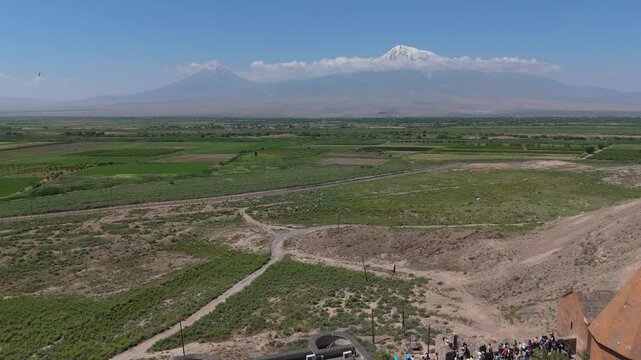  Aerial view Armenian flag. Drone fly around Armenian flag and cross with mountains background. he concept of liberty, patriotism, independence day, celebration, patriotic, power.