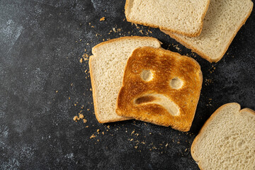Gluten food, celiac disease, slice of toasted bread with sad face. Gluten sensitivty