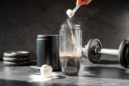 Amino acid food supplement, creatine powder in a measuring scoop, Sports nutrition 