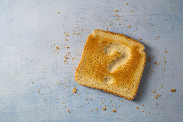 Gluten food, celiac disease, slice of toasted bread with question sign. Gluten sensitivty