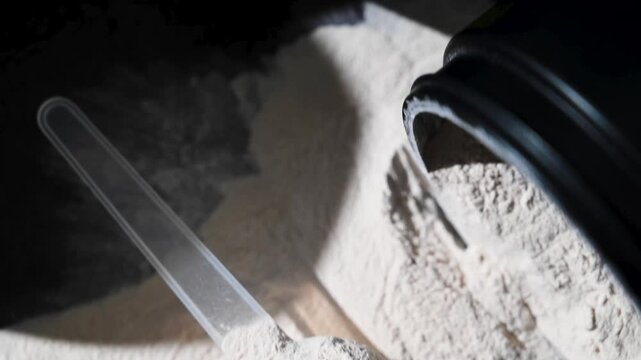 Amino acid food supplement, creatine powder in a measuring scoop, Sports nutrition 