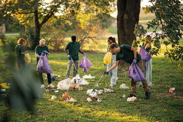 Group of people volunteers picking up trash in park