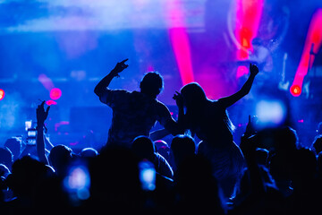 Crowd cheering and having fun at live rock concert