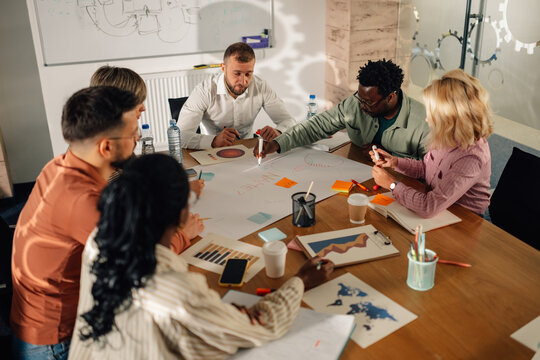 Marketing team working on a project, sharing ideas and planning strategy during a meeting