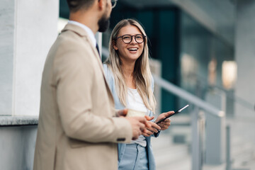 Business people having conversation during coffee break outdoors
