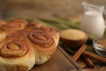 Freshly baked cinnamon rolls on wooden table, closeup