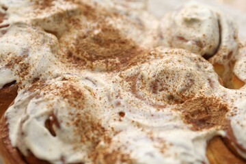 Delicious frosted cinnamon rolls as background, closeup