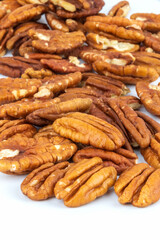 Pecan halves on a white background. Nuts.