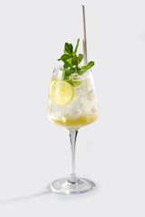 Fresh Hugo spritz cocktail with lemon, mint, straw and ice, stock, on white background