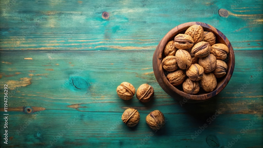 Aufkleber a rustic wooden bowl overflowing with shelled walnuts on a weathered teal plank surface