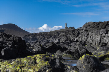 Farol da Ponta dos Capelinhos lighthouse at Faial island of the Azores, Portugal. Former beacon on...