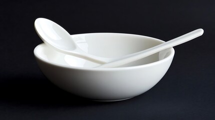 White bowl containing a neatly arranged spoon and fork