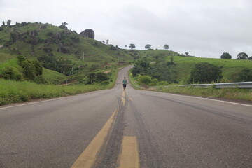 homem caminhando em rodovia