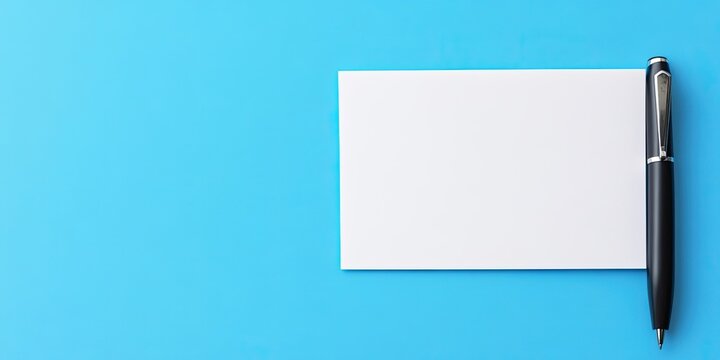 Blank white note paper and black pen on blue background, positioned right with space for text, ideal for reminders or to-do lists.