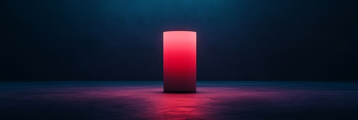 A glowing red cylinder stands in a dimly lit space, creating a striking contrast against the dark background.
