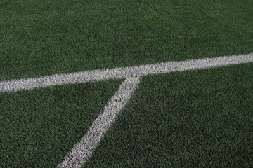 Obraz premium Soccer concept, The green synthetic grass soccer field with white line. Sports background for product display, banner, mockup, and more