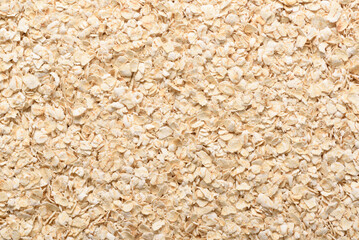 Instant oat flakes texture background. Healthy breakfast contain a variety of nutrients and dietary...